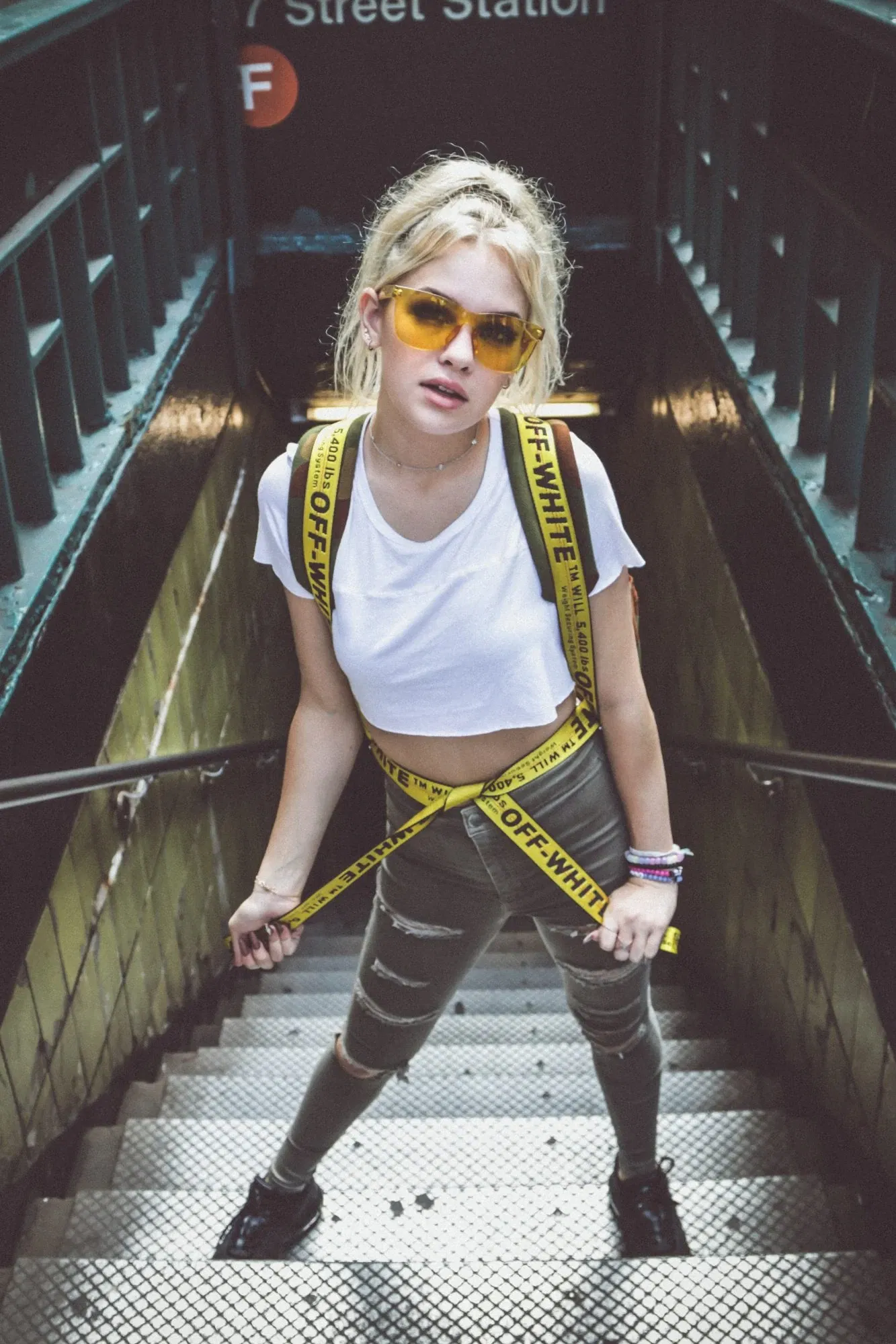 woman on stairs with branded clothing